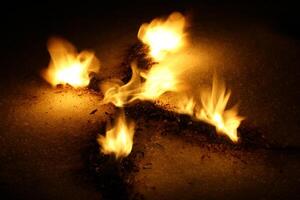 Burning wood shavings on the snow in cross or runic shape photo