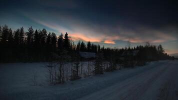HDR image of nacreous clouds over Swedish farm buildings in winter photo