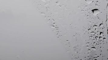 Raindrops on window glass surface closeup. Closeup shot of water drops on car windshield. Fall season background with copy space video