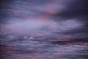 Impressive cloudscape, lightly illuminated by the sun below photo