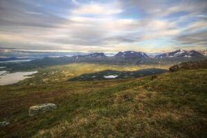 In summer nights here on Mount Nuolja, the mountain casts a shadow on Abisko valley photo