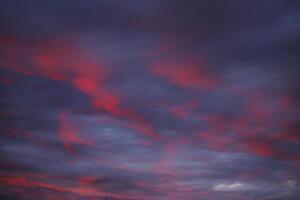 Impressive cloudscape, illuminated by the sun below photo
