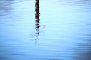 Reflection of concrete pillar on lake Menstrask photo