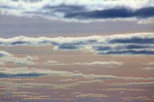 Pastel colored cumulus clouds in northern Sweden photo