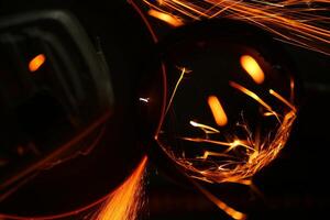 Cutting a metal pipe with angle grinder photo