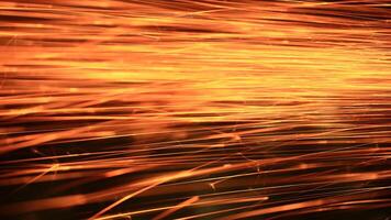 Spraying sparks from metalworking on a dark background photo