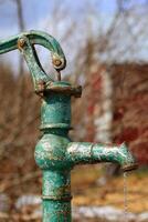 A rusty old piston pump in Sweden photo