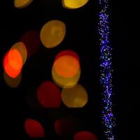 Abstract shot of string lights becoming blurry color spots photo