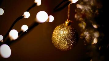 Close-up of golden sparkling christmas tree ball photo
