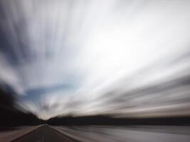 Blurred shot of backlit forest, symbolizing speed photo