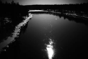 Reflection of moon on Skellefte River in Swedish lapland photo