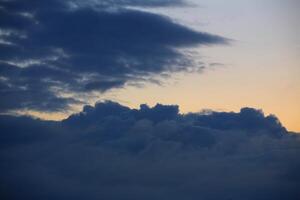 Blue cumulus clouds on a summer evening photo