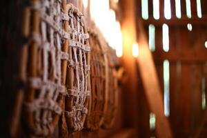 Row of traditional snow shoes hanging on a wall in an old barn photo