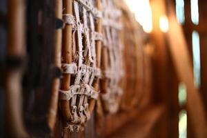 Row of traditional snow shoes hanging on a wall in an old barn photo