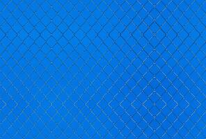 Seamlessly tileable texture of wire mesh on a blue sky photo