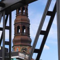 Hamburger Michel, St Michaels church in Hamburg, with defocused steel bridge frame in foreground photo