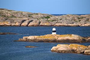 Rock cairn marking the waterway at the rocky coast of Smogen in Sweden photo
