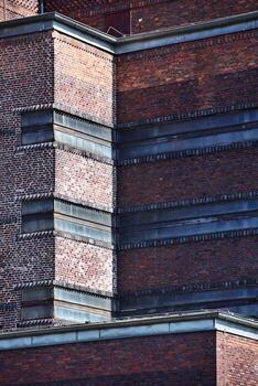Detail of grungy brick expressionism building in sunlight photo