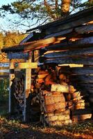 Pile of firewood in Sweden, the sign says Ved - Firewood photo