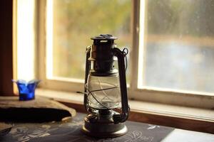 Close up of an oil lamp at the window photo