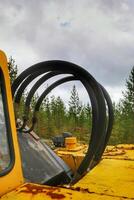 Hydraulic tubes of an old and rusty excavator photo
