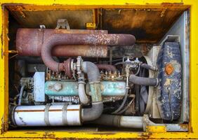 Engine bay of an old and rusty excavator photo
