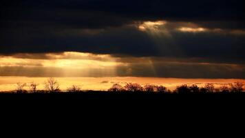 Sunbeams breaking through cloud cover in backlit shot photo