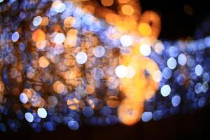 Beautiful bokeh of defocused blue and yellow christmas decorations photo