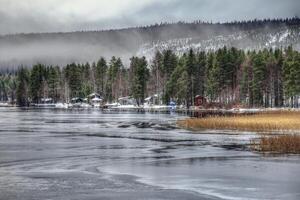 View over lakeside of Lake Norsjon in northern Sweden photo