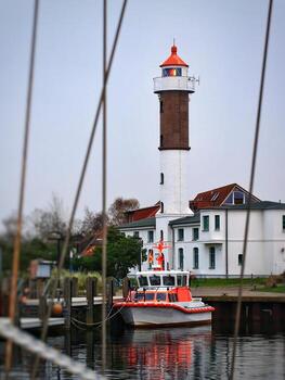 Port with lighthouse and defocused ropes in Timmendorf photo