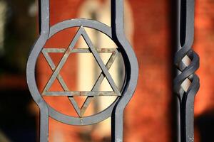 Star of david at the gate of a jewish cemetery photo