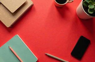 Flat Lay Office layout Desktop red background, Minimalist Stationery. photo