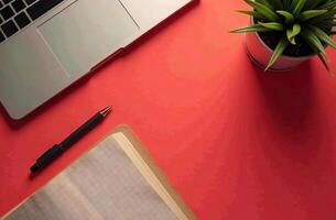 Flat Lay layout Office Desktop red background, Minimalist Stationery. photo