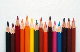 Pencils lie on white paper, art tool for hobby of drawing photo