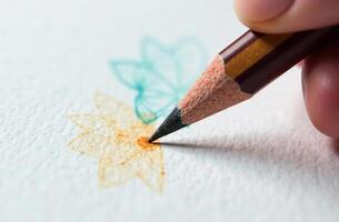 Hand hold pencil and draw parlour pattern, art tool for hobby of drawing photo