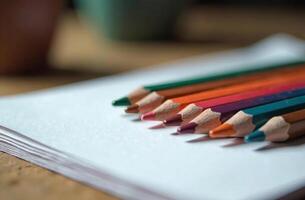 Pencils lie on white paper, art tool cabinet hobby of drawing photo
