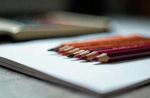 Pencils lie on white paper cabinet art tool for hobby of drawing photo