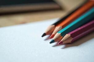 Pencils lie on white paper, art tool for cabinet hobby of drawing photo