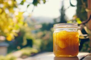 A jar of orange juice sitting on a table photo