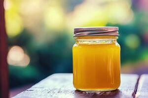 A jar of orange juice sitting on a table photo