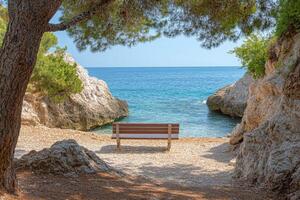 A bench sitting on a sandy beach next to a body of water photo