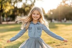 A little girl in a blue dress is jumping in the grass photo
