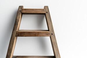 A wooden ladder against a white wall photo