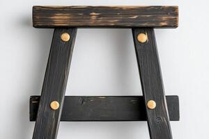 A black ladder with wooden legs and wooden handles photo