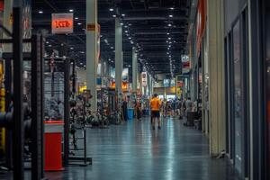 A man walking through a gym with a lot of equipment photo