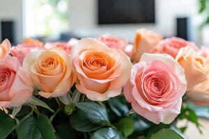 A vase of pink and orange roses sitting on a table photo