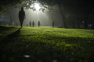 People walking in a park at dusk photo