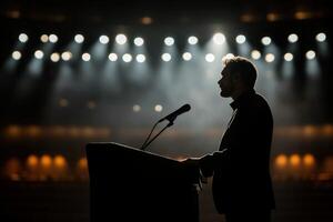Silhouette of a man giving a speech in front of a podium photo