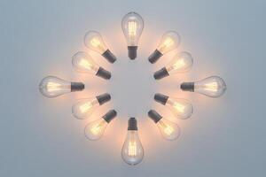 A circle of glowing vintage light bulbs on a neutral background photo