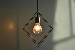 A Single Light Bulb Hanging From a Geometric Metal Frame photo